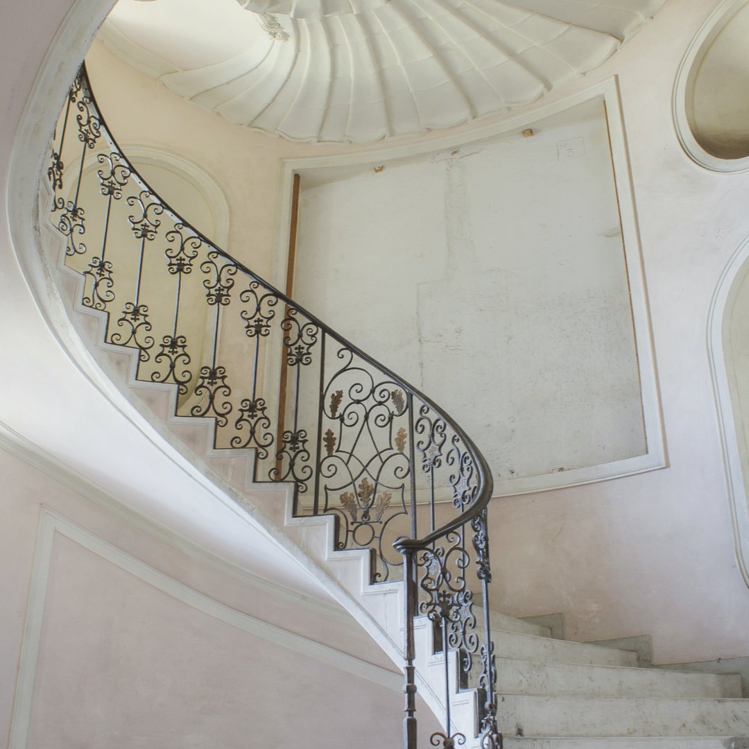 low-angle-view-spiral-staircase-abandoned-building-1080x1080
